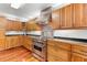 Well-equipped kitchen with wood cabinets, stainless steel appliances, and black countertops at 3116 Lakepoint Cir, Acworth, GA 30102