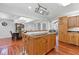 Bright eat-in kitchen featuring a large island, wood cabinets, and hardwood floors at 3116 Lakepoint Cir, Acworth, GA 30102