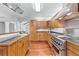 Open concept kitchen featuring hardwood floors, island, and stainless steel appliances at 3116 Lakepoint Cir, Acworth, GA 30102
