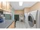 Spacious laundry room with machines, storage cabinets, wash sink, and plenty of room for cleaning supplies at 3116 Lakepoint Cir, Acworth, GA 30102