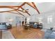 Open living room featuring hardwood floors, beamed ceilings, and ample seating at 3116 Lakepoint Cir, Acworth, GA 30102