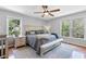 Bright main bedroom with hardwood floors, ceiling fan, and abundant natural light at 3116 Lakepoint Cir, Acworth, GA 30102