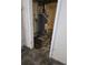 Water heater in unfinished basement with concrete walls and dark, stained floor at 6 Rockmart Sw Dr, Atlanta, GA 30314