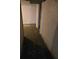 Narrow unfinished basement hallway with concrete walls and tile flooring at 6 Rockmart Sw Dr, Atlanta, GA 30314