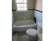 Small bathroom with a tub and toilet at 6 Rockmart Sw Dr, Atlanta, GA 30314