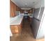 Kitchen with stainless steel fridge, wooden cabinets, and wooden flooring at 6 Rockmart Sw Dr, Atlanta, GA 30314