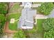 Aerial view of the home showcasing the layout, fenced yard, and the surrounding landscape at 11040 Regal Forest Dr, Johns Creek, GA 30024