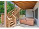 Back deck with steps leading to the yard and a hot tub under the deck at 11040 Regal Forest Dr, Johns Creek, GA 30024
