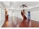 Finished basement with hardwood floors, custom bar and a staircase, ceiling fan, and neutral walls at 11040 Regal Forest Dr, Johns Creek, GA 30024