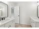 Bathroom featuring double sinks, quartz countertops and black fixtures at 11040 Regal Forest Dr, Johns Creek, GA 30024