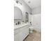 Bright bathroom with white cabinets, matte black fixtures and a large framed arch mirror at 11040 Regal Forest Dr, Johns Creek, GA 30024