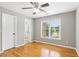 Bedroom with hardwood floors, natural light from large window and neutral paint at 11040 Regal Forest Dr, Johns Creek, GA 30024