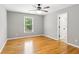Bedroom with hardwood floors, large windows, modern ceiling fan and neutral paint at 11040 Regal Forest Dr, Johns Creek, GA 30024