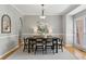 Well-lit dining room with a modern table, chairs, and a large window at 11040 Regal Forest Dr, Johns Creek, GA 30024