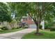 Beautiful brick home with a pristine lawn, mature trees, and convenient two-car garage at 11040 Regal Forest Dr, Johns Creek, GA 30024