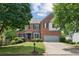 Charming two-story brick home featuring a well-maintained lawn and a two-car garage at 11040 Regal Forest Dr, Johns Creek, GA 30024