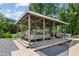 Community gazebo with built-in seating and wooden decking, perfect for gatherings at 11040 Regal Forest Dr, Johns Creek, GA 30024