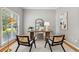 Stylish home office featuring a large desk, comfortable chairs, and natural light at 11040 Regal Forest Dr, Johns Creek, GA 30024