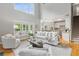 Open-concept living room with fireplace, kitchen view and natural light at 11040 Regal Forest Dr, Johns Creek, GA 30024