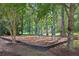 Community playground featuring swings and a wood chip ground cover, bordered by trees at 11040 Regal Forest Dr, Johns Creek, GA 30024