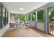 Screened sunroom with abundant natural light, wood floors and outdoor view at 11040 Regal Forest Dr, Johns Creek, GA 30024