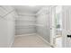 A large walk-in closet providing ample storage space with white wire shelving at 11040 Regal Forest Dr, Johns Creek, GA 30024