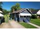 A charming blue one-story home with a covered porch and well-kept lawn in a suburban setting at 1286 Allene Sw Ave, Atlanta, GA 30310