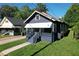 Quaint blue one-story home with covered porch, and a manicured lawn next to neighboring houses at 1286 Allene Sw Ave, Atlanta, GA 30310