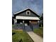 Charming home with dark exterior, covered porch, and walkway leading to a welcoming entrance at 1286 Allene Sw Ave, Atlanta, GA 30310