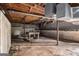 Unfinished basement features concrete block walls and exposed wood ceiling at 1491 Boulderwoods Dr, Atlanta, GA 30316