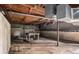 Exposed basement ceiling shows pipes, with cement flooring, cinder block walls and wood beams at 1491 Boulderwoods Dr, Atlanta, GA 30316