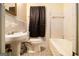 A full bathroom with a tub, toilet, and sink; basic style at 1491 Boulderwoods Dr, Atlanta, GA 30316