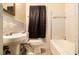 Cozy bathroom features a tub, a sink, a toilet, and tiled walls at 1491 Boulderwoods Dr, Atlanta, GA 30316