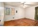 A basic bedroom with hardwood floors, two windows, and a ceiling fan at 1491 Boulderwoods Dr, Atlanta, GA 30316