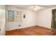 Modest bedroom featuring two windows bringing in natural light and hardwood flooring at 1491 Boulderwoods Dr, Atlanta, GA 30316
