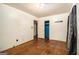 Simple bedroom features hardwood floors, an open closet, and natural light from the window at 1491 Boulderwoods Dr, Atlanta, GA 30316
