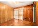This bedroom has hardwood floors, wood paneling, and a window at 1491 Boulderwoods Dr, Atlanta, GA 30316