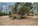 A charming brick home with mature trees and landscaping creates a serene setting at 1491 Boulderwoods Dr, Atlanta, GA 30316
