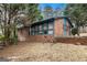 Charming brick home featuring well-maintained landscaping and mature trees at 1491 Boulderwoods Dr, Atlanta, GA 30316