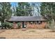 Charming single-story brick home with a well-maintained front yard and mature trees at 1491 Boulderwoods Dr, Atlanta, GA 30316