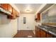 Traditional style kitchen featuring wood cabinets and a double basin stainless steel sink at 1491 Boulderwoods Dr, Atlanta, GA 30316
