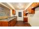 Galley kitchen featuring wooden cabinetry and dual basin sink for a functional cooking space at 1491 Boulderwoods Dr, Atlanta, GA 30316