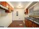 Modest kitchen featuring wood cabinets, laminate countertops and flooring, and natural light from a window at 1491 Boulderwoods Dr, Atlanta, GA 30316