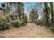 Expansive backyard with mature trees and lush greenery offers a private retreat at 1491 Boulderwoods Dr, Atlanta, GA 30316