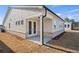 Exterior of the home with a patio and door, featuring neutral siding and a well-maintained backyard at 1783 Juniper Berry Way, Loganville, GA 30052