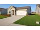 Charming single-story home with a well-manicured lawn and attached two-car garage at 1783 Juniper Berry Way, Loganville, GA 30052