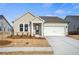 Charming single-story home showcasing a light exterior, manicured lawn, and an attached two-car garage at 1783 Juniper Berry Way, Loganville, GA 30052