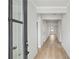 Bright hallway with neutral walls, hardwood flooring, and a view of the front door and other rooms at 1783 Juniper Berry Way, Loganville, GA 30052