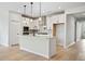 Modern kitchen features island, stainless appliances, and stylish white cabinets at 1783 Juniper Berry Way, Loganville, GA 30052