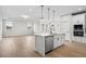 Open kitchen with island, stainless steel appliances, and hardwood floors at 1783 Juniper Berry Way, Loganville, GA 30052